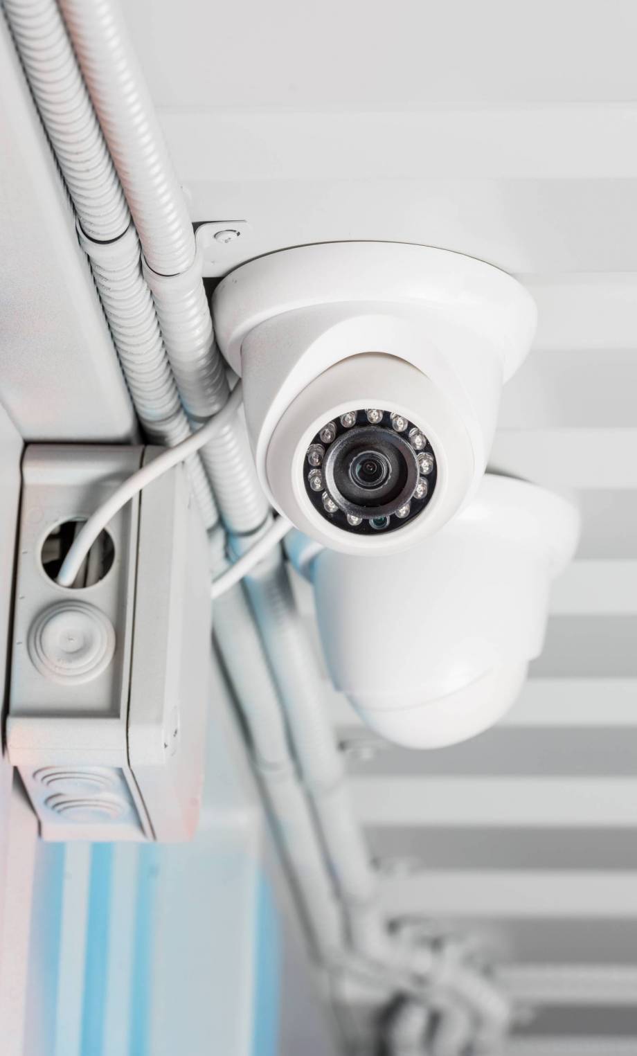 white security camera on ceiling, home security system concept